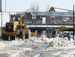 plow pushes snow to center of street