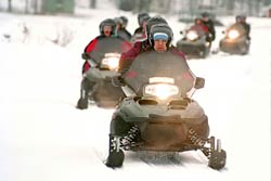a group of snowmobilers enjoying the day on the trails