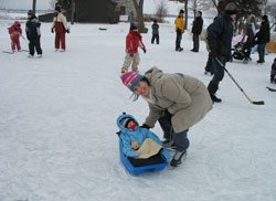 we pull our son a plastic snow sled while we go skating