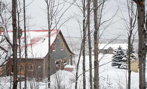 a sugar shack in a snowy quebec forest